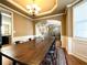Spacious dining room with hardwood floors, wainscoting, a large table, and a chandelier at 2585 Chandler Grove Dr, Buford, GA 30519
