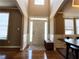 Bright foyer with hardwood floors, a white front door with sidelights, and a view into the dining room at 2585 Chandler Grove Dr, Buford, GA 30519