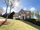 Attractive two-story brick home boasting an attached two-car garage and a well-maintained lawn with landscaping at 2585 Chandler Grove Dr, Buford, GA 30519