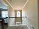 Upstairs hallway with chandelier and railing leading to bedrooms at 2585 Chandler Grove Dr, Buford, GA 30519