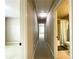 Hallway view showcasing neutral walls, carpet, and access to a bathroom at 2585 Chandler Grove Dr, Buford, GA 30519