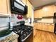 Kitchen with stainless steel gas range, granite countertops, and wood cabinets at 2585 Chandler Grove Dr, Buford, GA 30519