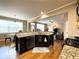 Open concept kitchen featuring a dark island, stainless steel appliances, and hardwood floors at 2585 Chandler Grove Dr, Buford, GA 30519