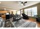 Living room features hardwood floors, leather furniture, large windows and views of the kitchen at 2585 Chandler Grove Dr, Buford, GA 30519