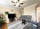 Cozy living room with hardwood floors, ceiling fan and staircase at 2585 Chandler Grove Dr, Buford, GA 30519