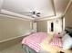 Spacious main bedroom with tray ceiling, fan, and ensuite bathroom at 2585 Chandler Grove Dr, Buford, GA 30519