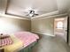 Spacious main bedroom with tray ceiling, fan, and view to hallway at 2585 Chandler Grove Dr, Buford, GA 30519