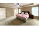 Spacious main bedroom with tray ceiling, fan, and ensuite bathroom at 2585 Chandler Grove Dr, Buford, GA 30519