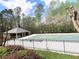 Community pool featuring a covered lounge area and a fenced perimeter amid a lush green space at 2585 Chandler Grove Dr, Buford, GA 30519