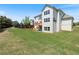 Grassy backyard featuring a two-story home with a wooden deck and a privacy fence at 4250 Harrison Lndg, Cumming, GA 30041