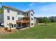 Spacious backyard featuring a two-story home with a wooden deck on the second floor at 4250 Harrison Lndg, Cumming, GA 30041