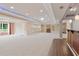 Expansive basement with carpet, fireplace, wet bar, and tray ceiling with recessed lighting, offering versatile space at 4250 Harrison Lndg, Cumming, GA 30041