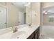 A bathroom features a double sink vanity with dark wood cabinets, a large mirror, and neutral paint at 4250 Harrison Lndg, Cumming, GA 30041