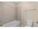 An alcove bathtub and toilet are set against neutral tile, with a towel bar to the right at 4250 Harrison Lndg, Cumming, GA 30041
