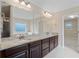 Bathroom featuring granite countertops, dual sinks, a large mirror, and a soaking tub with a view at 4250 Harrison Lndg, Cumming, GA 30041
