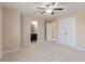 An empty bedroom with neutral walls, neutral carpet, and an open doorway to a bathroom at 4250 Harrison Lndg, Cumming, GA 30041