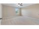 Bright, neutral bedroom featuring a ceiling fan, large window, and plush carpet at 4250 Harrison Lndg, Cumming, GA 30041