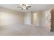 An empty bedroom with neutral walls, neutral carpet, ceiling fan, and an open doorway at 4250 Harrison Lndg, Cumming, GA 30041