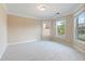 Neutral carpeted bedroom with large windows offering plenty of natural light and views of the outdoors at 4250 Harrison Lndg, Cumming, GA 30041