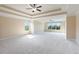 A spacious bedroom features neutral paint, tray ceiling, ceiling fan, and large windows at 4250 Harrison Lndg, Cumming, GA 30041