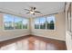 Bright, airy bedroom with hardwood floors and large windows offering expansive views of lush greenery at 4250 Harrison Lndg, Cumming, GA 30041