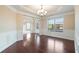 Dining room with tray ceiling, modern chandelier, chair rail, and view of the front yard at 4250 Harrison Lndg, Cumming, GA 30041