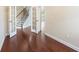 Spacious entryway with hardwood floors and white trim, with the stairway visible through the open doorway at 4250 Harrison Lndg, Cumming, GA 30041