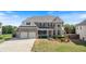 Beautiful two-story brick home with a well-manicured lawn, three-car garage and covered front porch at 4250 Harrison Lndg, Cumming, GA 30041