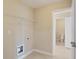 Laundry room includes tile floors, wire shelving, and leads into the water closet at 4250 Harrison Lndg, Cumming, GA 30041