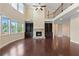 Spacious living room featuring a stone fireplace, hardwood floors, soaring ceilings and large windows at 4250 Harrison Lndg, Cumming, GA 30041