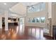 Open-concept layout featuring hardwood floors, fireplace, lots of windows, connecting the living room and kitchen at 4250 Harrison Lndg, Cumming, GA 30041