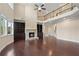 Spacious living room features a stone fireplace, dark wood floors, and a view of the second story at 4250 Harrison Lndg, Cumming, GA 30041