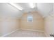 A spacious walk-in closet with neutral carpeting, ample shelving and a window for natural light at 4250 Harrison Lndg, Cumming, GA 30041