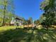 Large backyard featuring a swing set, outdoor seating, and mature trees at 6010 Silver Lace Nw Ln, Acworth, GA 30101