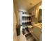 Well-lit bathroom with white fixtures and a shower featuring a black and white curtain at 6010 Silver Lace Nw Ln, Acworth, GA 30101