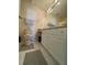 Bright bathroom features white cabinets, large mirror, and neutral tile flooring at 6010 Silver Lace Nw Ln, Acworth, GA 30101