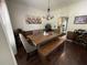Elegant dining room with a wooden table and bench seating, perfect for Gathering meals and entertaining guests at 6010 Silver Lace Nw Ln, Acworth, GA 30101