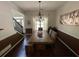 Stylish dining room with a farmhouse table, chandelier, and rich wood floors, ideal for dinner parties at 6010 Silver Lace Nw Ln, Acworth, GA 30101