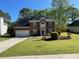 Charming two-story red brick home with a manicured front lawn and attached garage at 6010 Silver Lace Nw Ln, Acworth, GA 30101