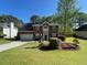 Charming two-story brick home featuring manicured lawn and a decorative flower garden in the front yard at 6010 Silver Lace Nw Ln, Acworth, GA 30101