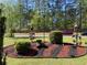Nicely landscaped front yard with bushes, flowerbeds, birdhouse, and a street view at 6010 Silver Lace Nw Ln, Acworth, GA 30101