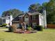Charming two-story brick home featuring manicured lawn and a decorative flower garden in the front yard at 6010 Silver Lace Nw Ln, Acworth, GA 30101