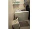 Functional laundry area featuring a washer, dryer, shelving, and laundry baskets at 6010 Silver Lace Nw Ln, Acworth, GA 30101