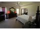 Spacious main bedroom featuring tray ceilings, dark wood furniture, and abundant natural light at 6010 Silver Lace Nw Ln, Acworth, GA 30101