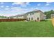 Spacious back yard view with lush lawn, fenced in area, patio and view of neighboring houses at 814 Lakehaven Ln, Loganville, GA 30052