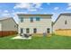 View of the home's rear exterior showcasing a manicured lawn, patio seating, and well-maintained siding at 814 Lakehaven Ln, Loganville, GA 30052
