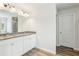 Bright bathroom with dual vanity, laminate floors, and a large mirror at 814 Lakehaven Ln, Loganville, GA 30052