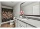 Charming bathroom with a shower curtain, wood-look floors, and granite countertops at 814 Lakehaven Ln, Loganville, GA 30052
