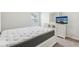 Clean bedroom with a plush mattress, a white dresser and a television on top at 814 Lakehaven Ln, Loganville, GA 30052