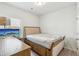 Cozy bedroom showcasing a twin bed, wooden dresser, and a bright window view at 814 Lakehaven Ln, Loganville, GA 30052